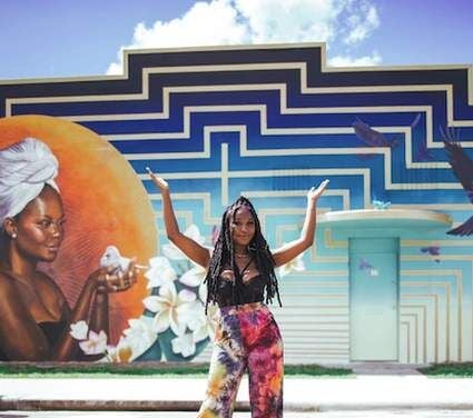 A UCF Alumni helps create a mural in the heart of Orlando